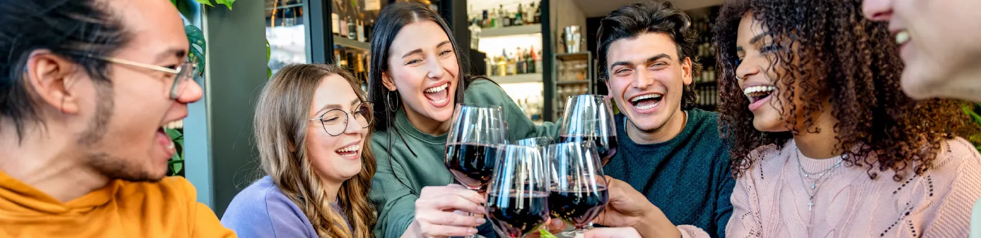 Friends sharing wine around table.
